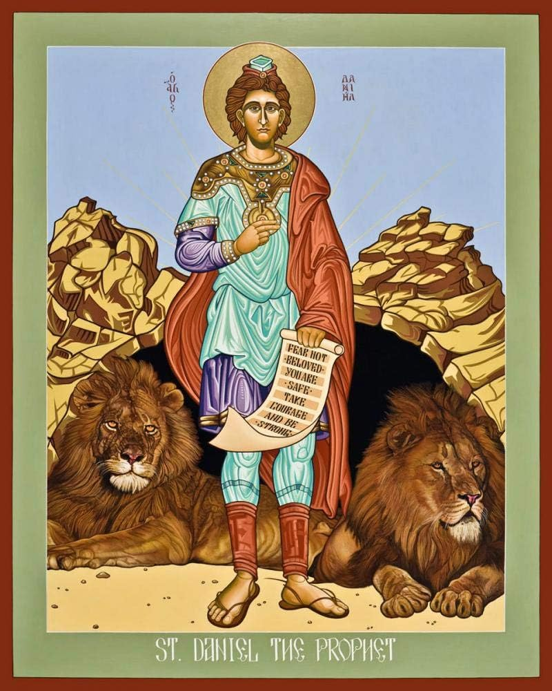 Icon-style illustration of Daniel standing facing us, back to two calm lions. Daniel is haloed and bearded, wears fine clothes, and holds a scroll.